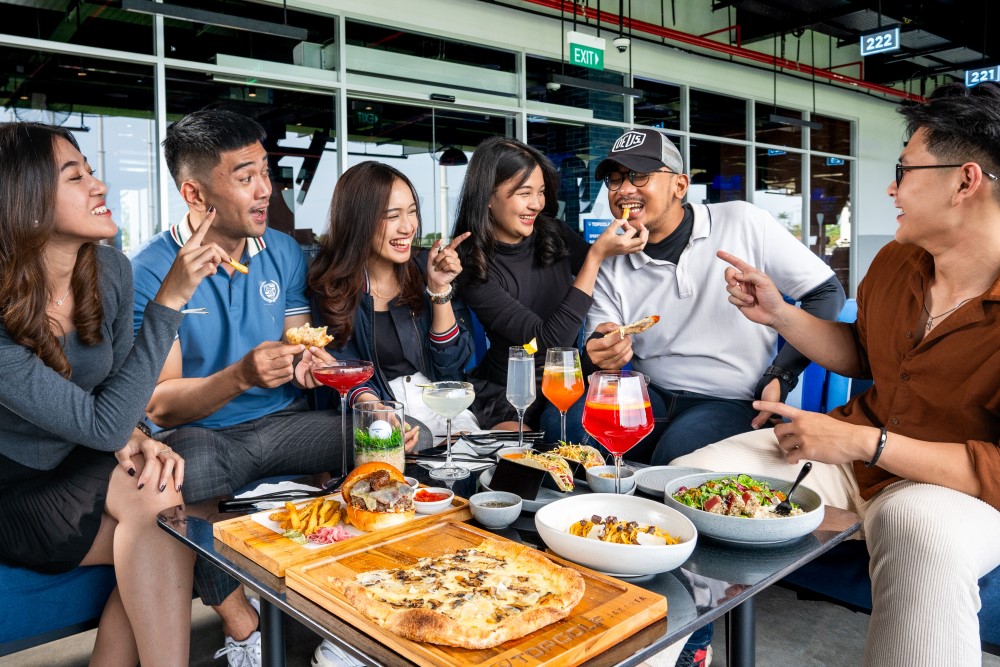 People dining and having fun together at Topgolf venue.
